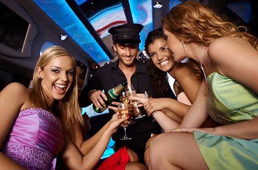 Thre young women celebrating in a limo with champagne